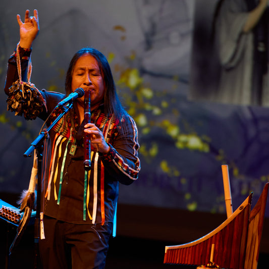 Edgar on stage with musical instruments, performing at river rock in Richmond BC